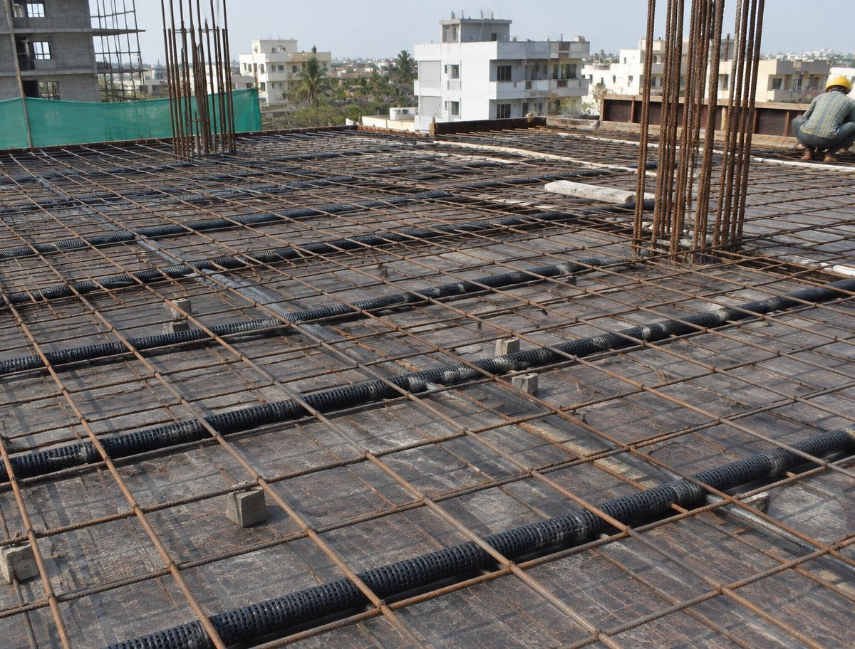 Pipes laid between slab rebar before concrete pouring